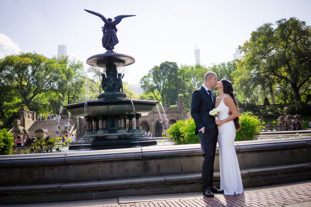Bride and groom kissing at Bethesda Terrace