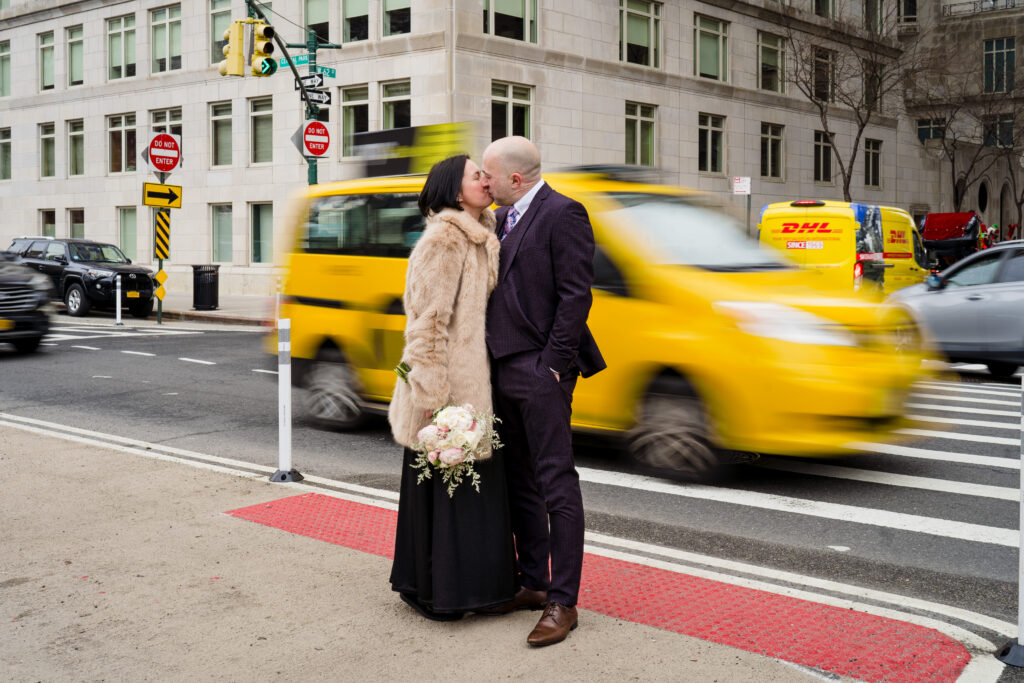 NYC taxi and couple after Central Park wedding