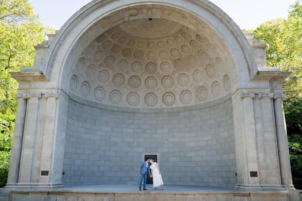 Wedding couple kissing at Naumburg Bandshell in Central Park