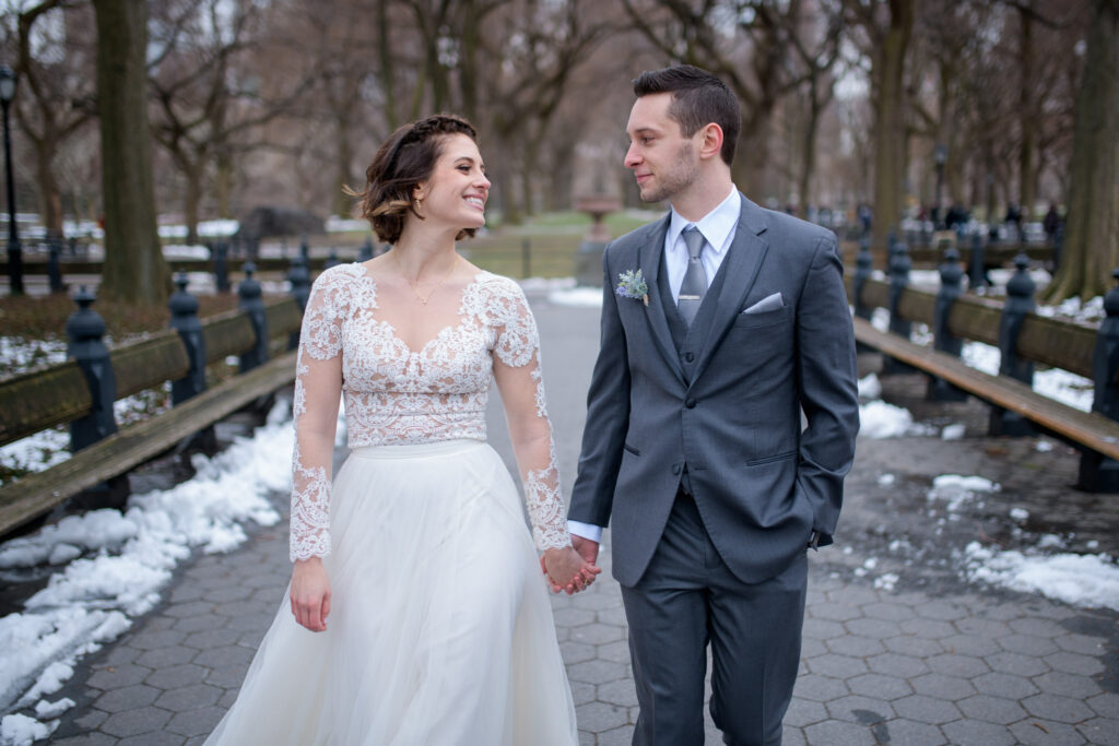Bride and groom walking through Central Park's Mall